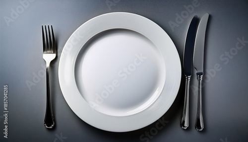 empty white plate with knife and fork