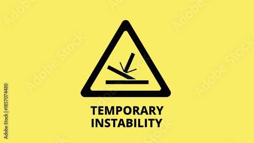 Yellow warning sign with a black triangular symbol indicating temporary instability, showing an object falling onto an uneven surface, with text below.