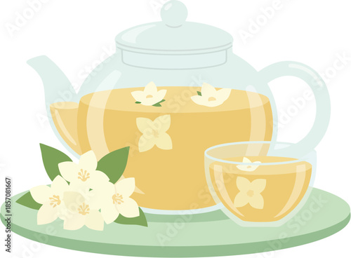 Glass teapot and cup with fragrant jasmine flower tea on a saucer.