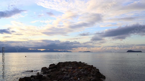 Seaside town of Turgutreis and spectacular sunsets. Bodrum, Turkey. A large rock in the middle of the Aegean Sea.	

