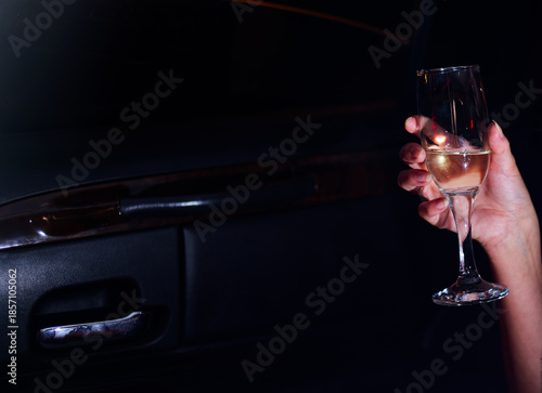 Wallpaper Mural Luxury Leisure: Elegant Hand Holding Champagne Glass Inside Car During Night Out Celebration Emphasizing Sophistication and Exclusive Lifestyle Vibe Torontodigital.ca