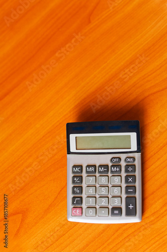 Wallpaper Mural Business Calculation: Electronic Calculator on Wooden Surface in Office Environment, Vertical Shot Torontodigital.ca