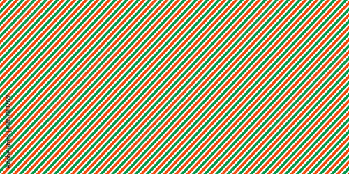Christmas seamless pattern. Red and green diagonal stripes background. Candy cane repeating decoration wallpaper. Winter holiday lines backdrop. vector