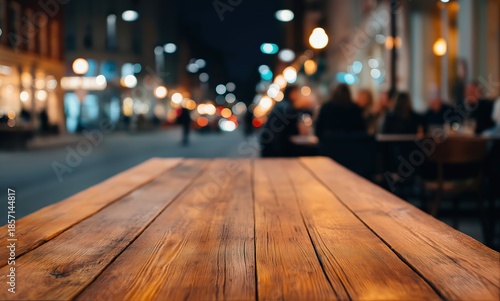Wooden table surface in foreground, blurry city street background with people dining and glowing bokeh light circles