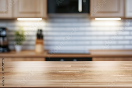 Empty wooden kitchen countertop providing copy space for product display, with blurred domestic interior focusing on modern design