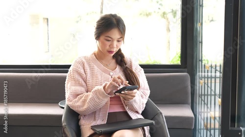 A young woman works on a laptop while sitting in a modern café, enjoying a quiet moment with coffee, reflecting a freelance lifestyle, remote work, and productivity in a cozy space.