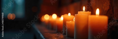 Close-up of flickering candle flames in a darkened room, casting soft, warm light on a vigil; peaceful, contemplative atmosphere ,  fire,  peace