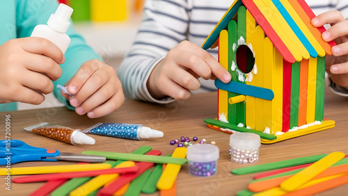 Two children creating a colorful birdhouse