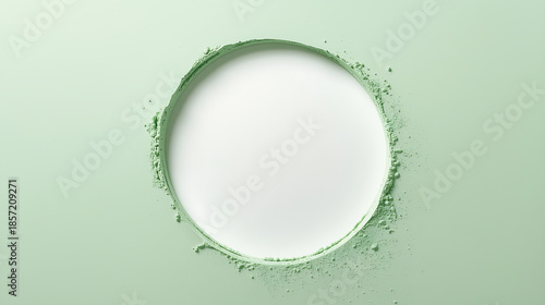 A minimalist flat-lay design showcases a smooth circular cut-out of white negative space on a pastel green powder-textured surface. The green powder creates rounded edges with subtle depth and shadows