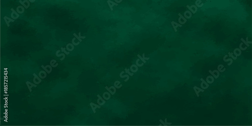 Blank vintage green chalkboard background with a grunge textured pattern and light paint strokes on an old empty wall design