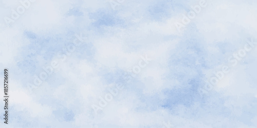 Beautiful fluffy white cumulus clouds drift across a clear blue summer sky in a natural bright day atmosphere