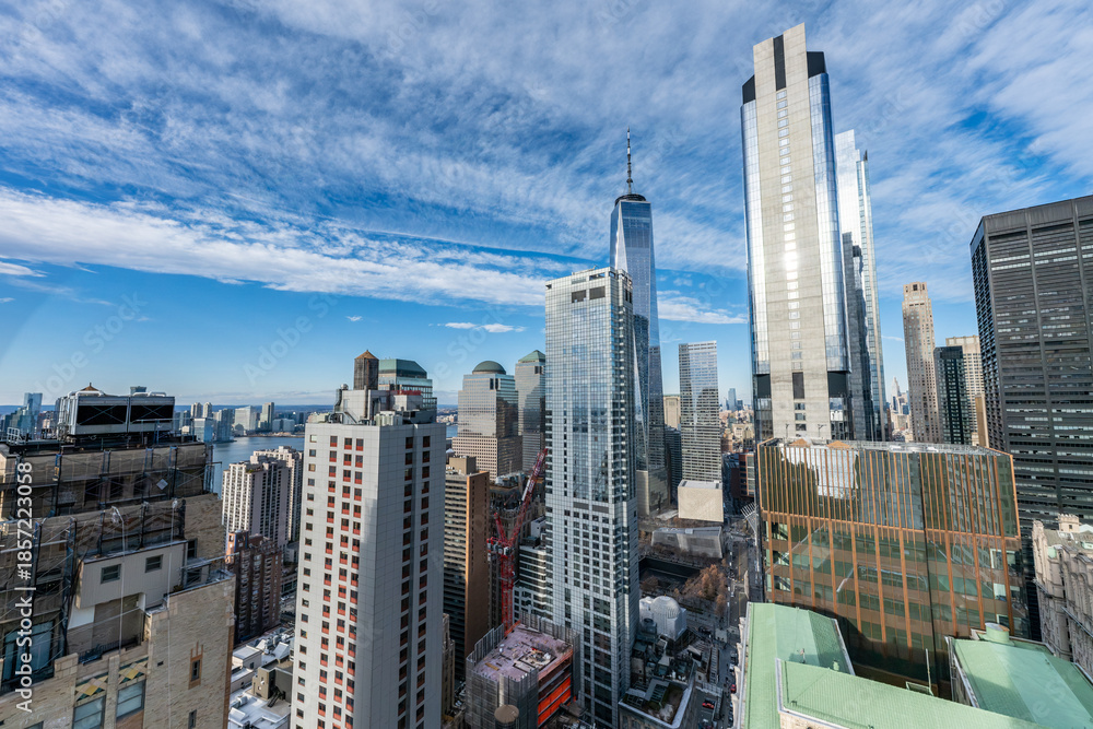 Obraz premium New York City skyline with One World Trade Center and East River under blue sky