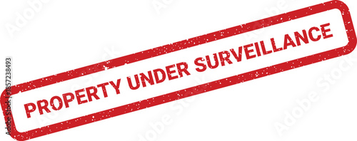 A red rectangular textured rubber stamp with the bold phrase property under surveillance for security warnings