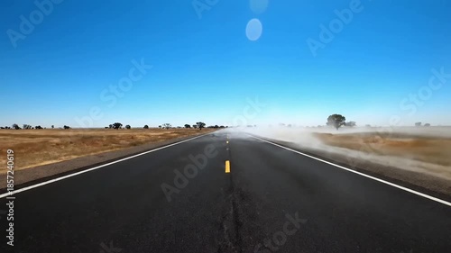 Distant Road Horizon heat shimmer summer A long, straight stretch of empty asphalt road under a blazing summer sun, focusing on the