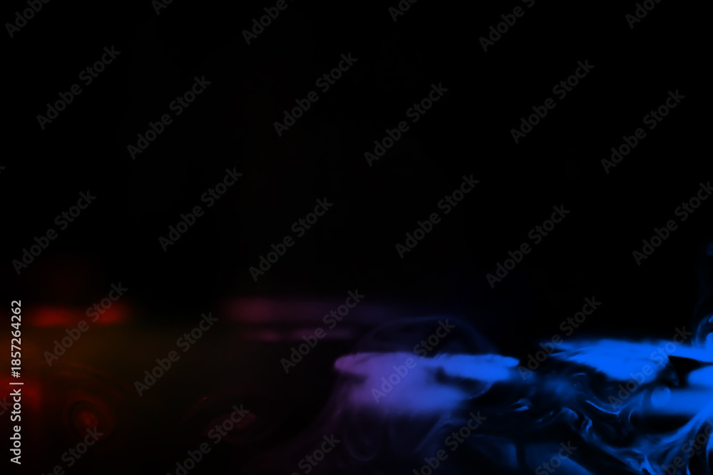 Fototapeta premium colorful smoke on dark background. Color steam on a black background. Red and blue smoke. Copy space.