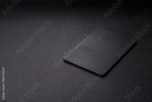 A black slate stone board or plate, an empty kitchen utensil. A black slate board