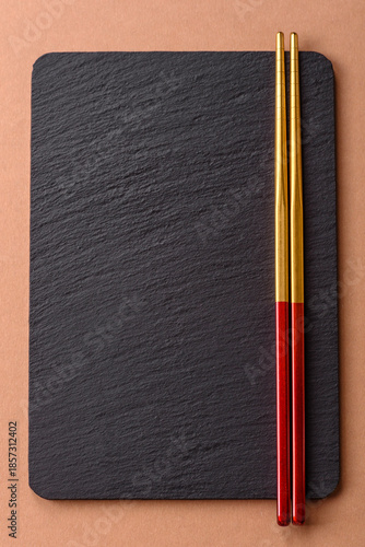 A black slate stone board or plate, an empty kitchen utensil. A black slate board