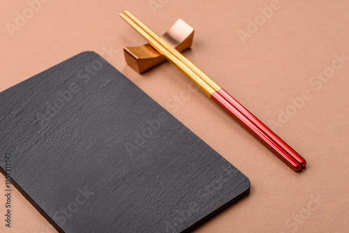 A black slate stone board or plate, an empty kitchen utensil. A black slate board