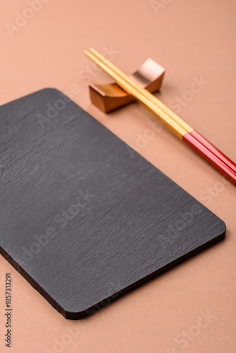 A black slate stone board or plate, an empty kitchen utensil. A black slate board
