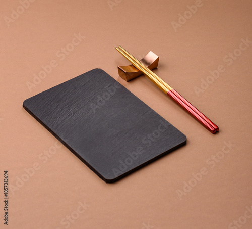 A black slate stone board or plate, an empty kitchen utensil. A black slate board
