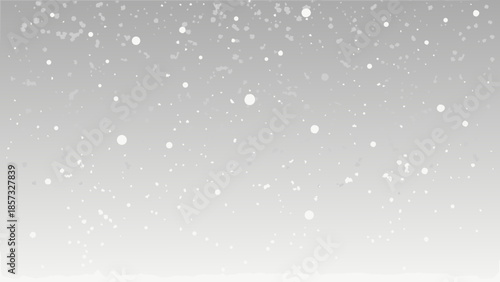 A gentle snowfall with delicate white flakes falling on a gray background