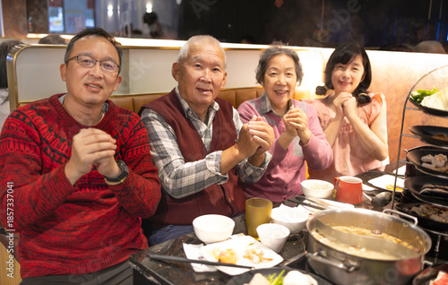 Happy Chinese family celebrating  lunar New Year in restaurant