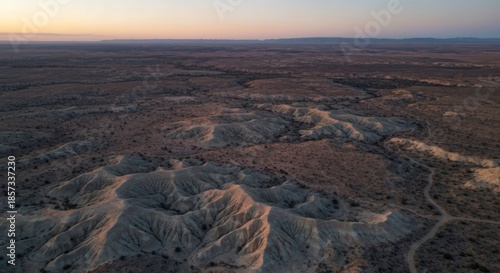 High-angle view of arid landscape, pale earth tones,  sunlit