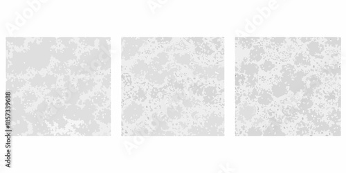 Abstract triptych display with a subtle speckled gray and white pattern