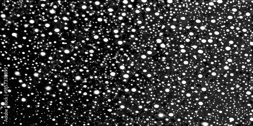 A striking black and white image depicting a dense field of scattered bright spots