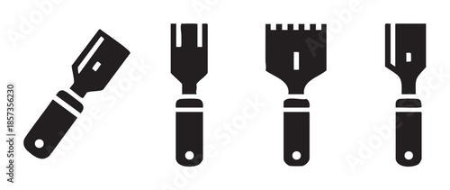 Scraper tools collection featuring various types of spatulas and putty knives used for construction, art, and home improvement projects.