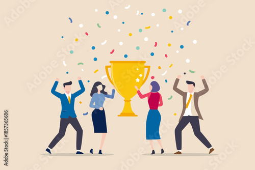 Celebrating success a team raises their arms around a golden trophy