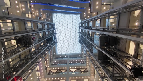 Photos Modern building atrium with glass elevators moving up