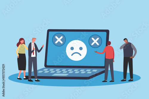 People facing a large laptop displaying an error message with sad emoticons