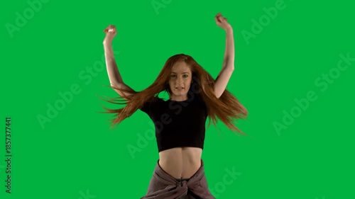 Beautiful woman dancing against black background