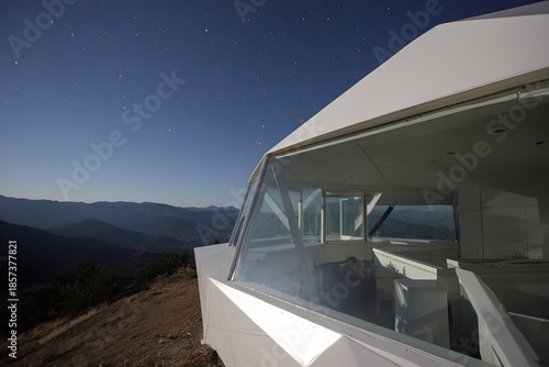 Modern White Cabin on Mountaintop at Night