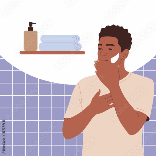 A thoughtful man applies skincare cream in a cozy bathroom, reflecting self-care practices and the importance of personal grooming in a serene environment.
