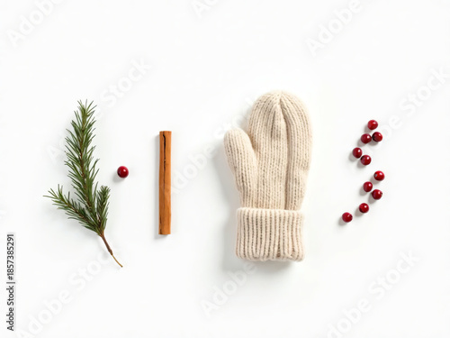 Top-down flat lay of minimalist winter items on white