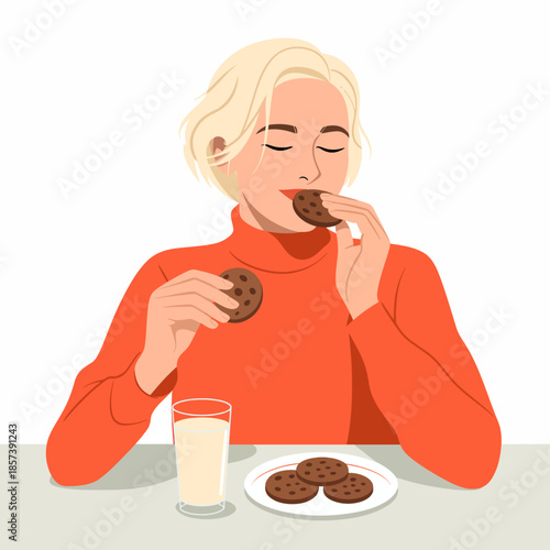 A woman with short blonde hair savoring chocolate cookies while holding a glass of milk, illustrating a cozy and joyful snack time experience at a simple table.