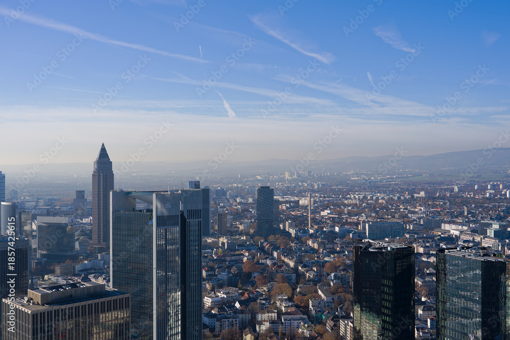 Fototapeta premium Aerial view from viewing platform of Main Tower platform with skyline and blue sky background on a sunny autumn day. Photo taken November 22nd, 2025, Frankfurt am Main, Germany.