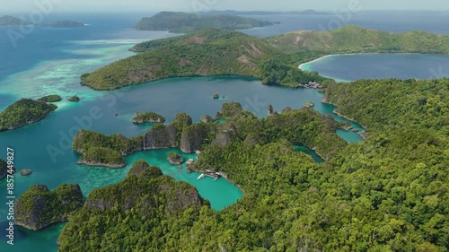 Raja Ampat, Indonesia: Aerial drone footage of the famous Piaynemo viewpoint plateform overlooking a stunning lagoon in the Fam islands in Raja Ampat in west Papua in Indonesia.