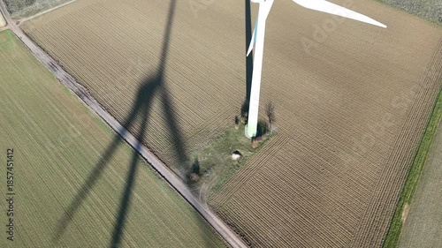 Aerial Wind Turbine Casting Shadow Across Agricultural Fields