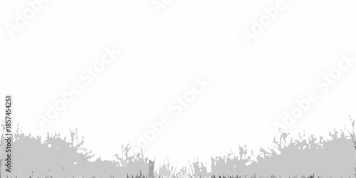 A blurred grayscale image depicting foliage and indistinct shapes