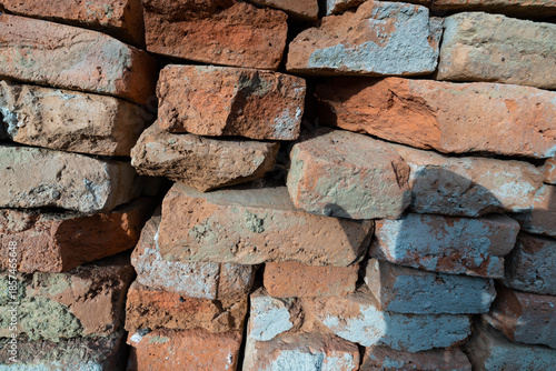 Used, broken bricks close up shot for industrial background.