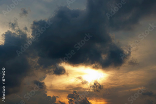 Golden Light Piercing Through Stormy Clouds. Sunset or sunrise Cloudscape. Golden Hour. Nature Background. High quality photo