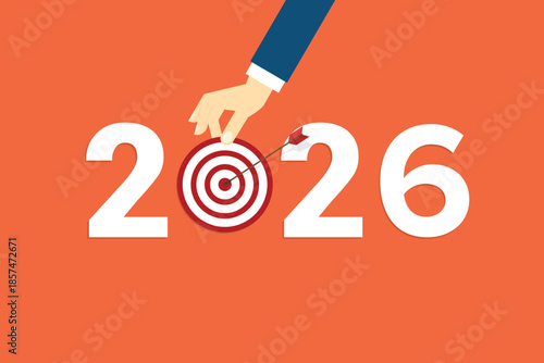 Human hand holding business target for a business year 2026. Red arrow hits target center. Business success concept.	