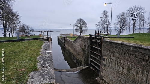 Sweden. Canal and sluice in the town of Berg on Lake Roxen. A ship is sailing along the canal. Ostergotland province. 