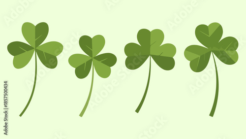 Four green shamrocks with stems on a light green background, symbolizing luck and Ireland.