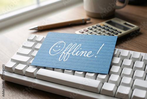 Blue note card with offline message on computer keyboard, digital detox and work life balance office concept.