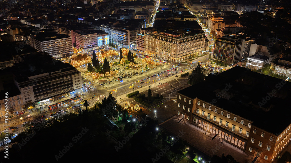 Fototapeta premium Aerial drone photo of illuminated festive Syntagma square featuring Greek Parliament and Christmas tree during New Year's Eve, Athens centre, Attica, Greece