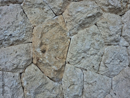 Natural stone wall texture with irregular rock pattern, rough surface background for architecture and outdoor design